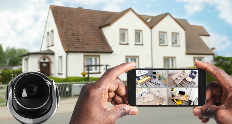Man holding smartphone and viewing streams from surveillance cameras